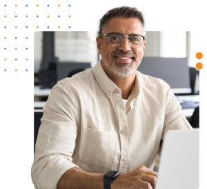 Middle-aged man smiling while on his computer