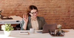 Photo of a woman recording at her desk recording a one-way video interview