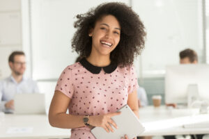 happy young intern on the job holding a tablet