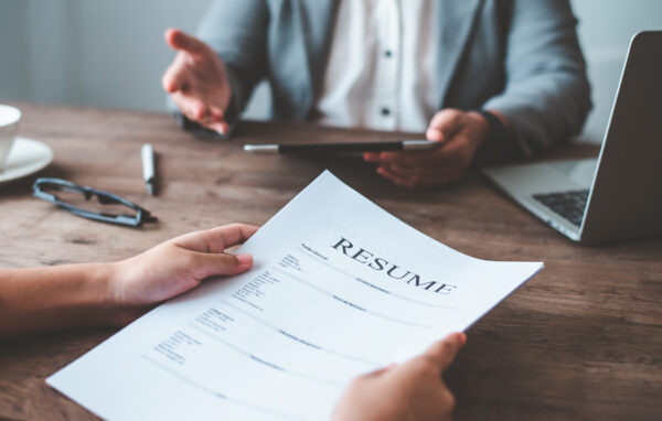 Job candidate resume on paper in the hands of a candidate