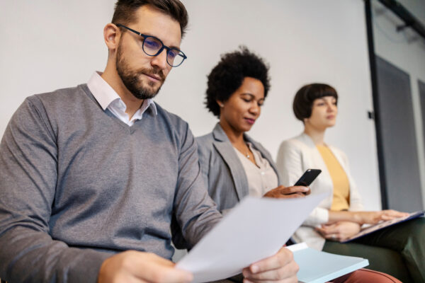 Job candidates sitting together waiting for job interview